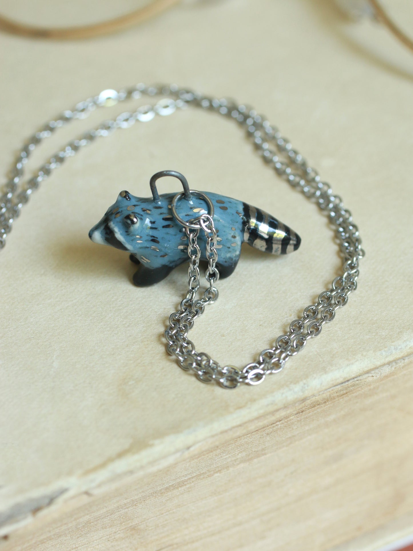 Ceramic raccoon necklace - silver details