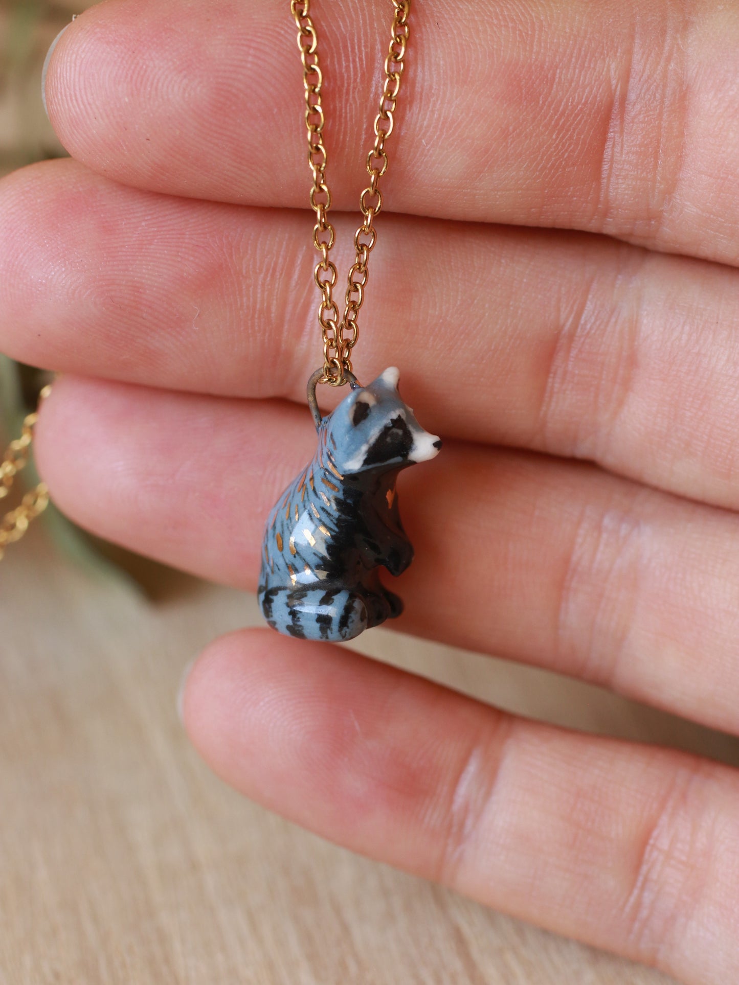 Raccoon necklace in a nutshell box