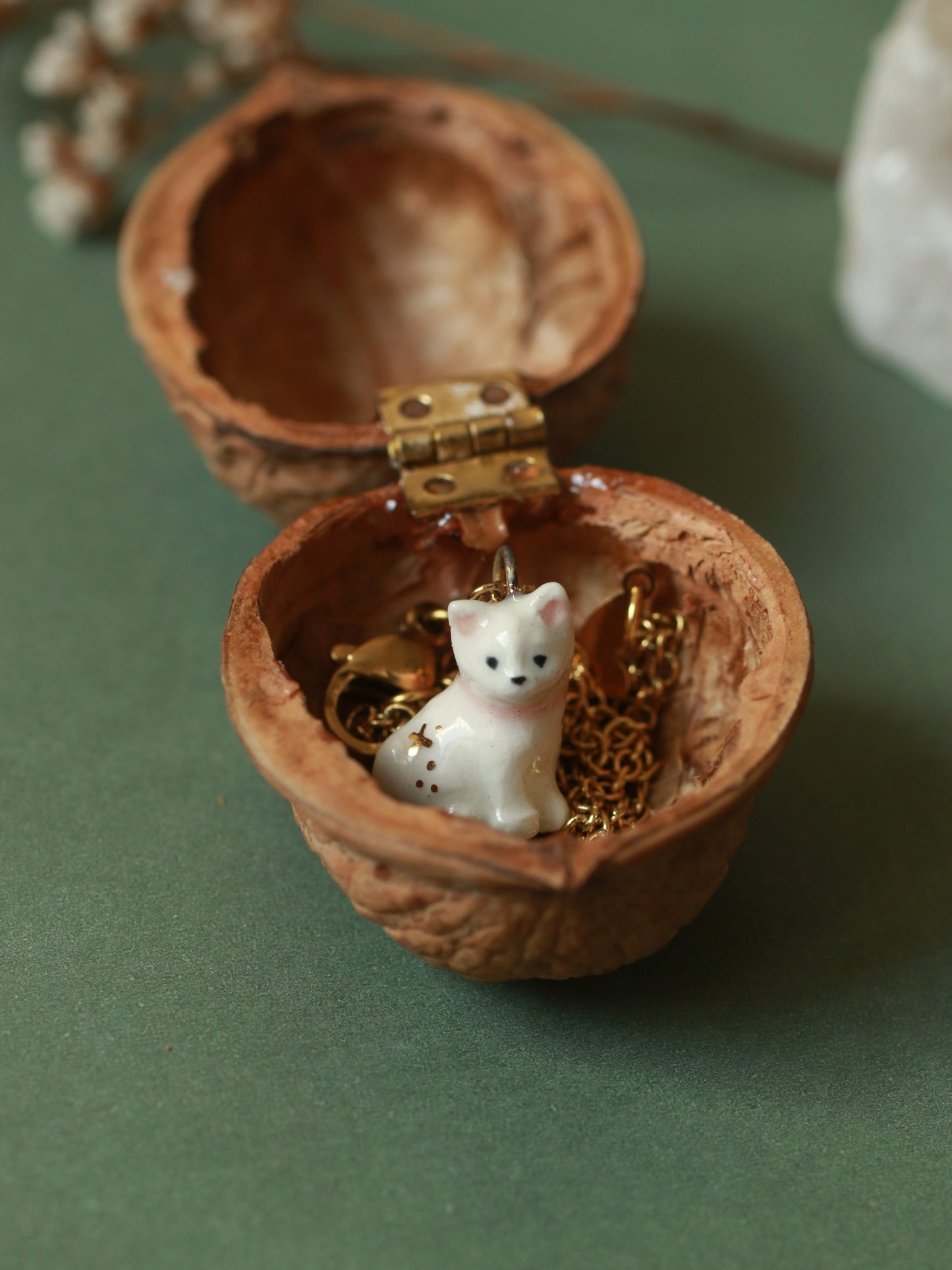 Tiny white cat necklace in a walnut box
