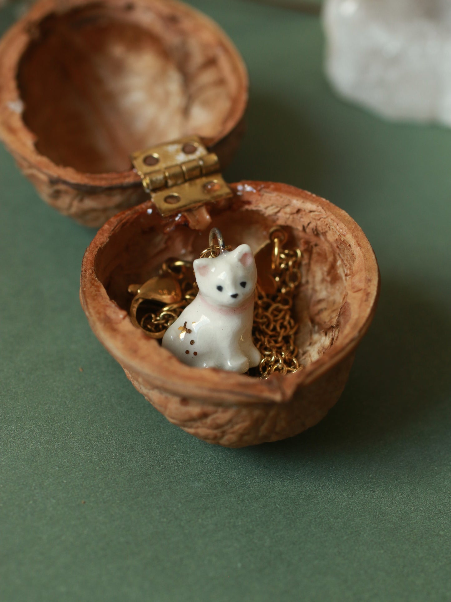 Tiny white cat necklace in a walnut box