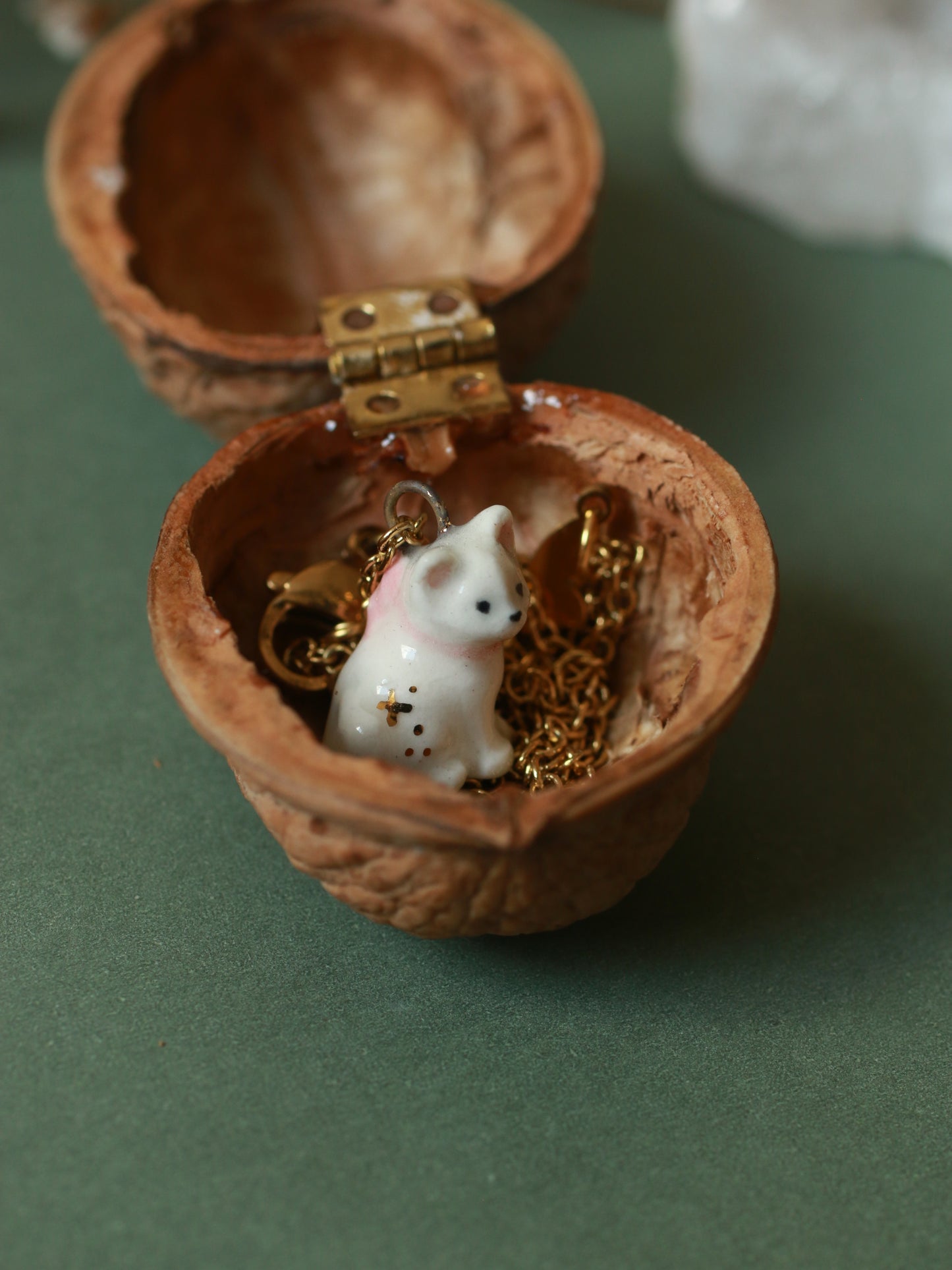 Tiny white cat necklace in a walnut box