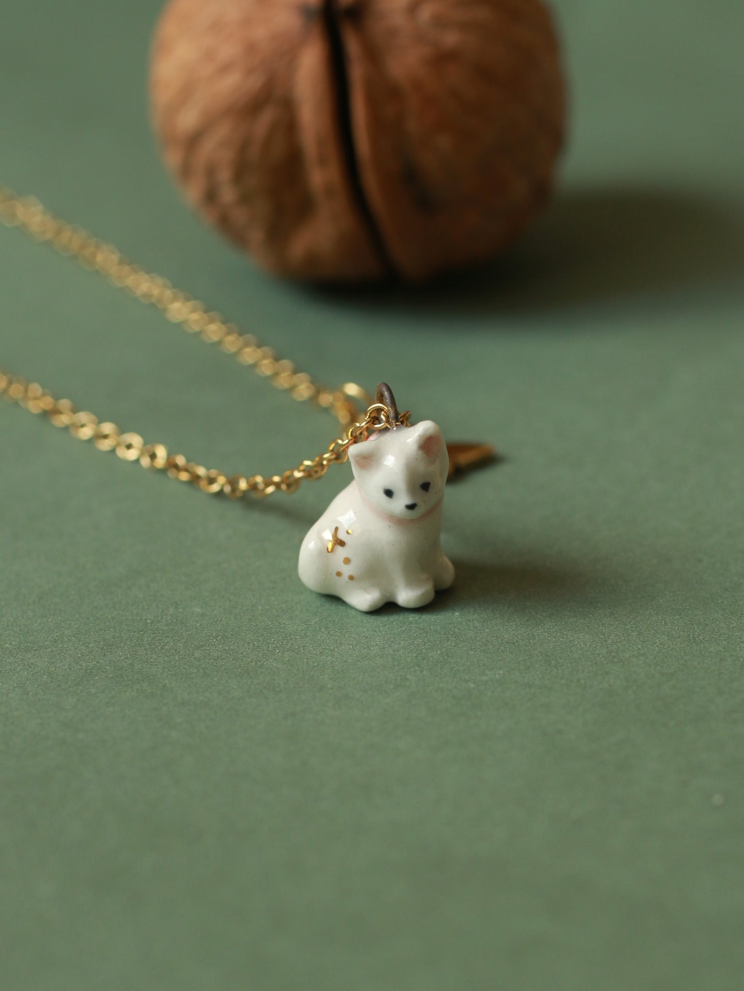 Tiny white cat necklace in a walnut box