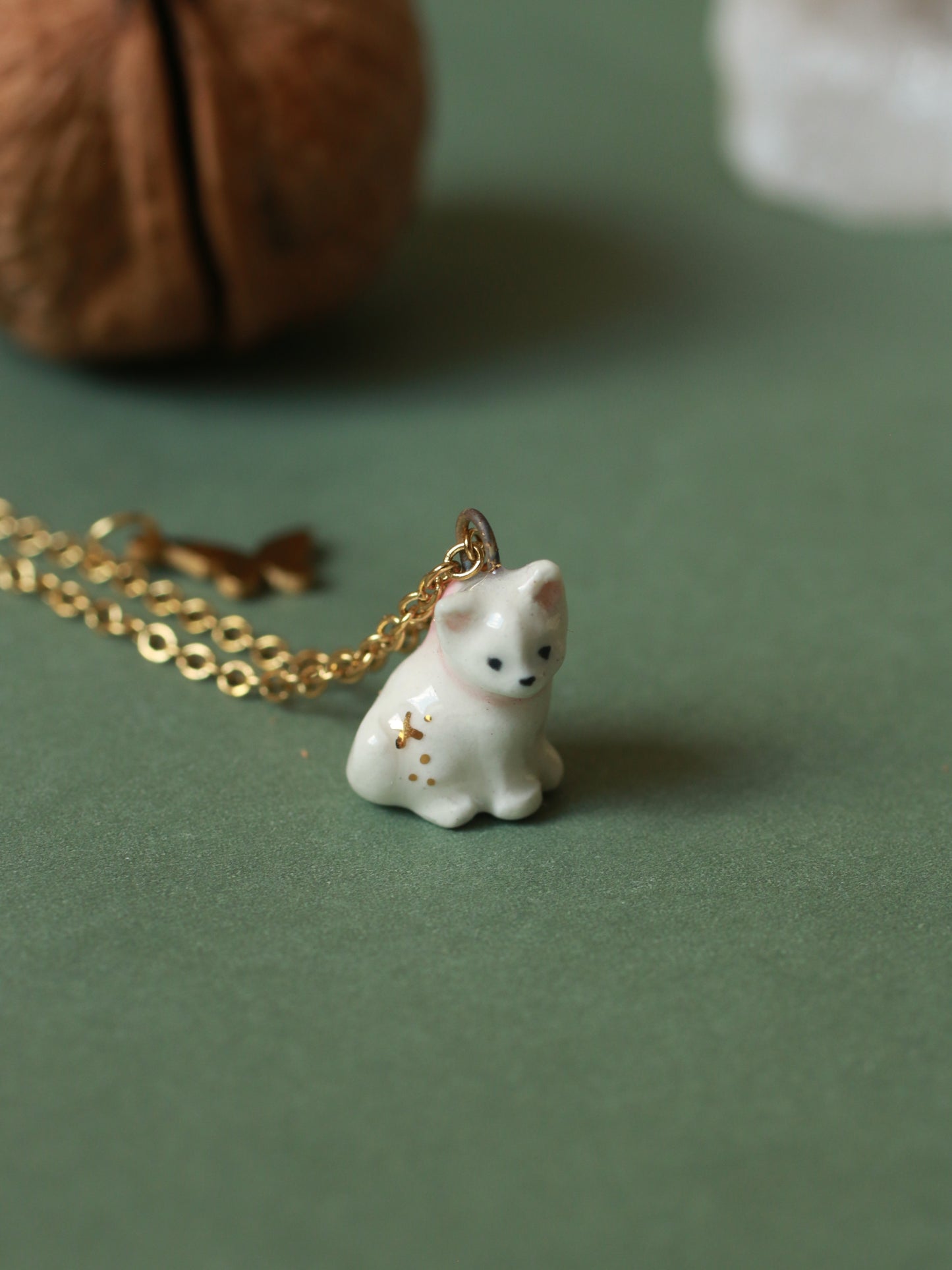 Tiny white cat necklace in a walnut box