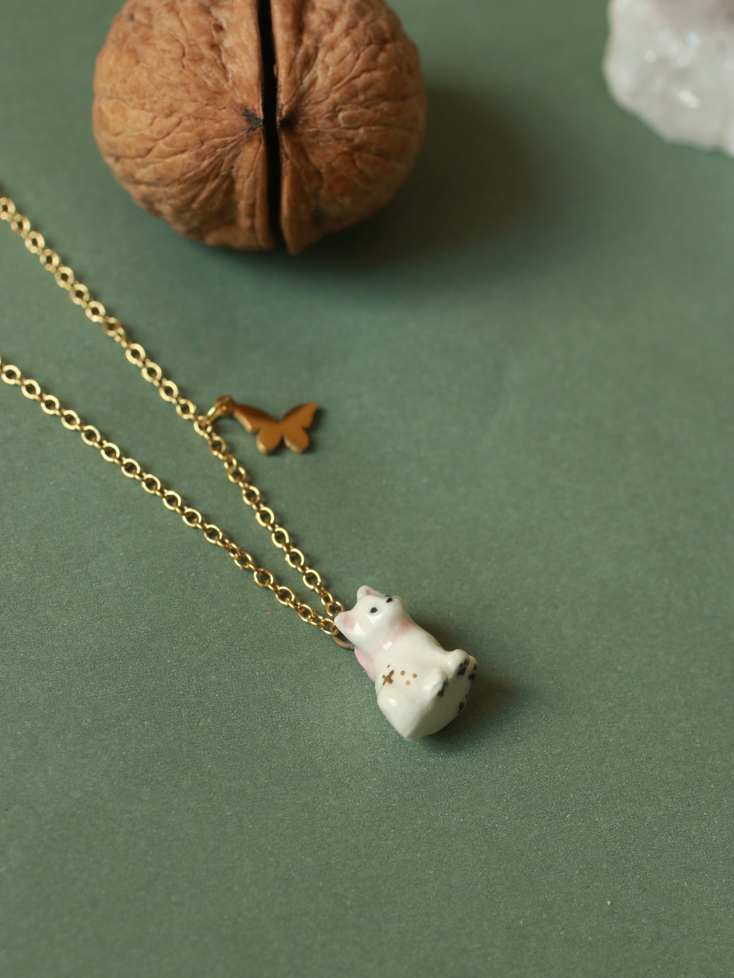 Tiny white cat necklace in a walnut box