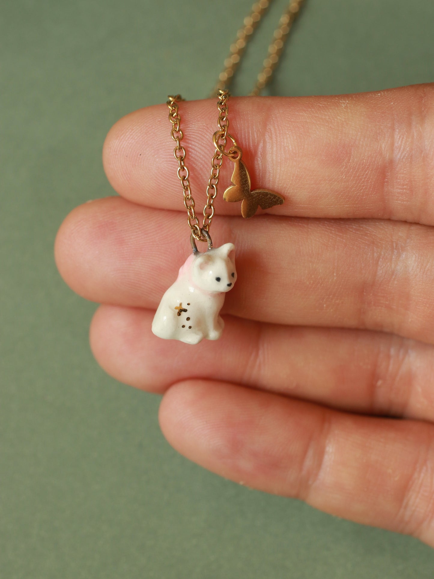 Tiny white cat necklace in a walnut box