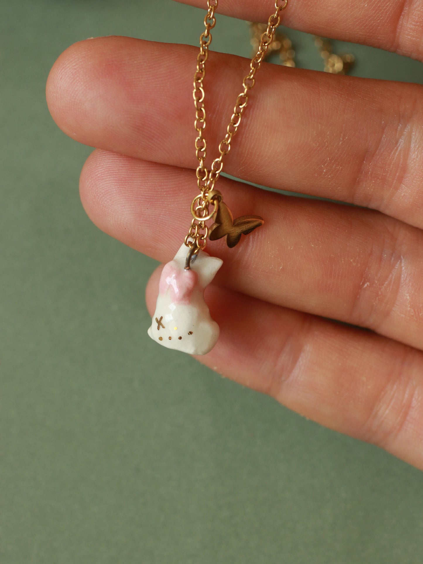 Tiny white cat necklace in a walnut box