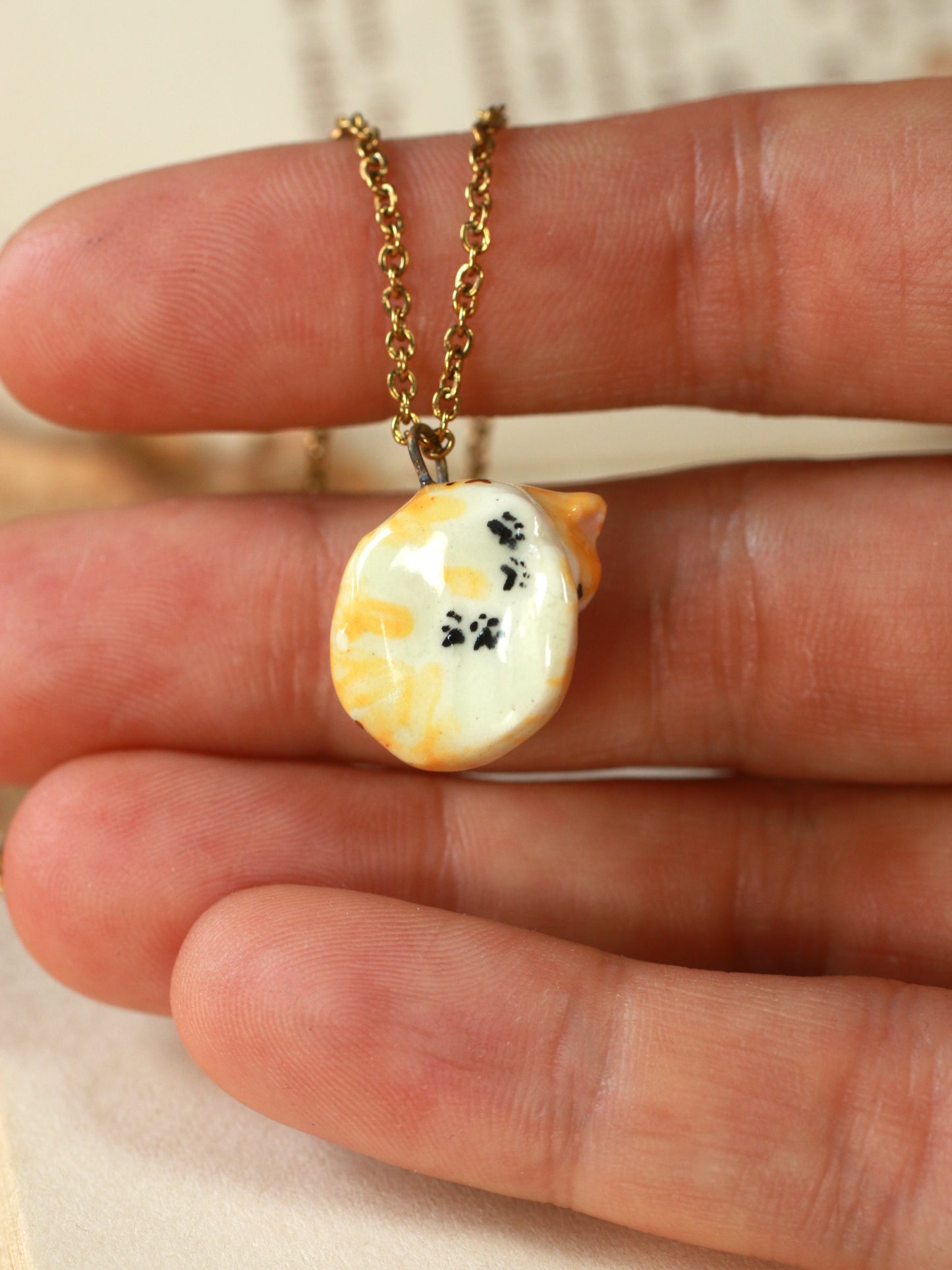 Sleeping orange tabby cat necklace