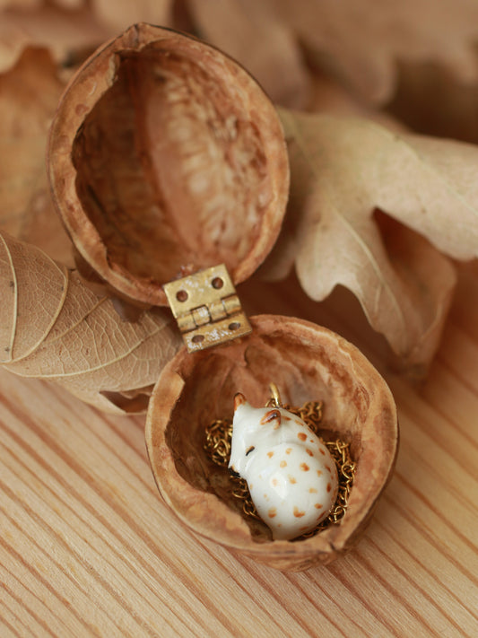 Sleeping piebald Fawn necklace in a walnut box