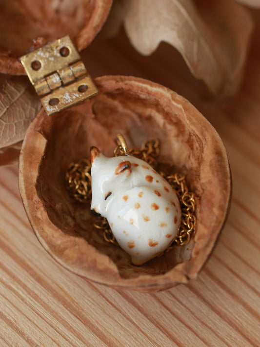 Sleeping piebald Fawn necklace in a walnut box