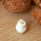 Baby barn owl figure in a walnut box