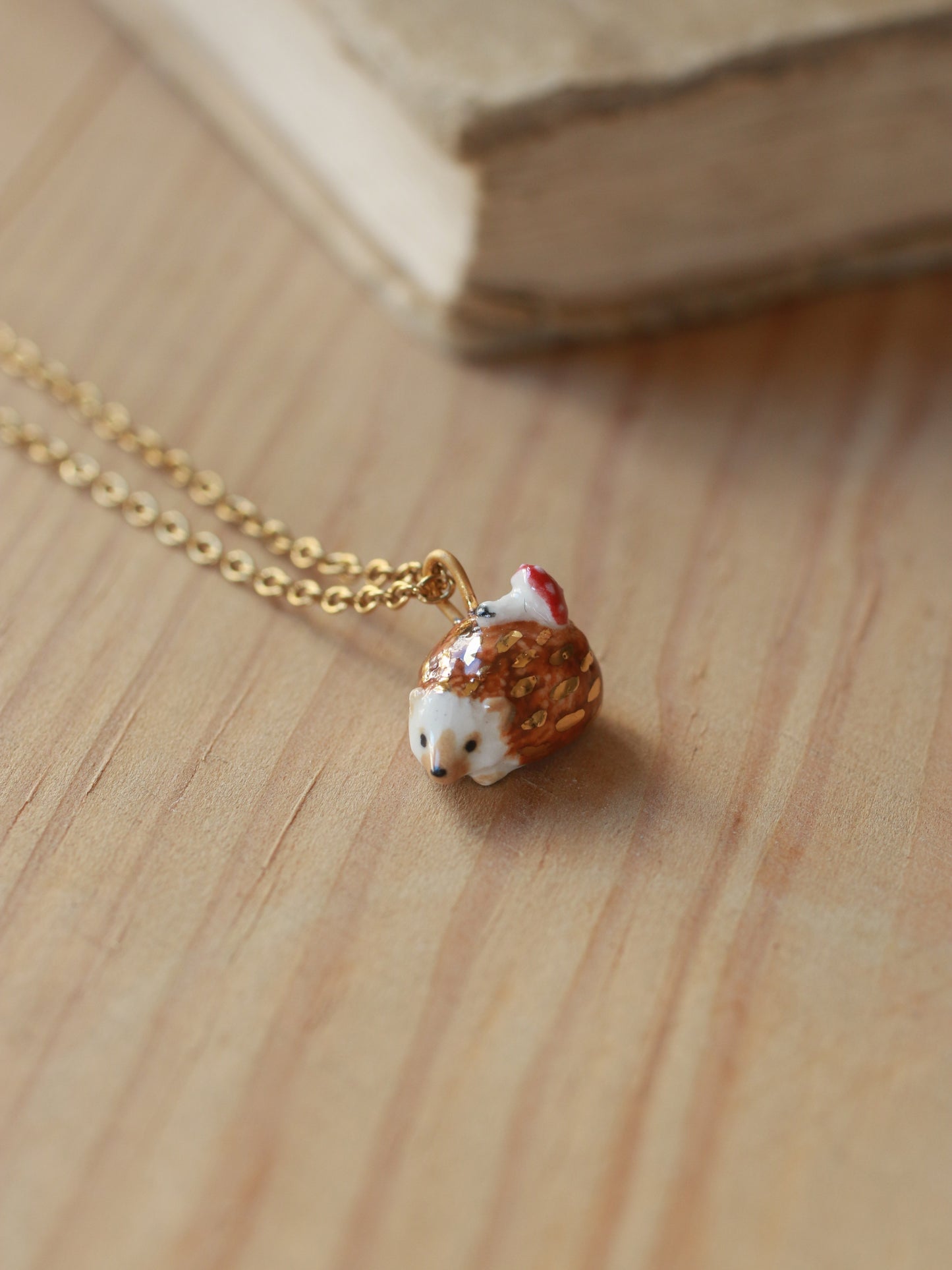 Hedgehog necklace with a tiny mushroom