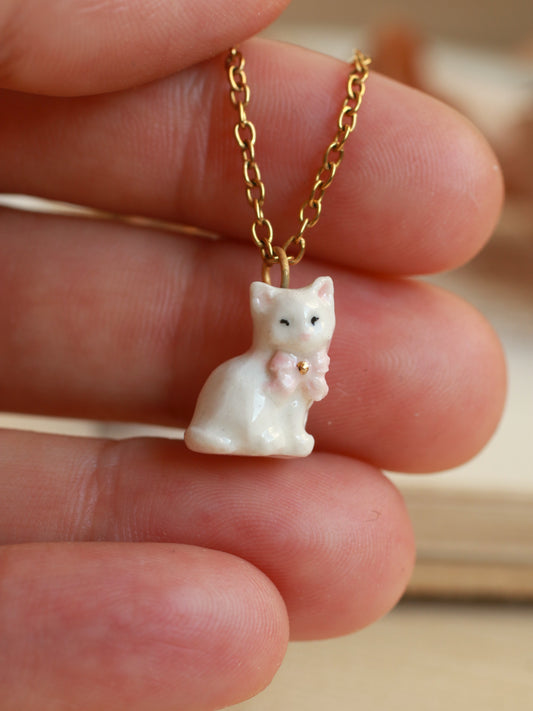 Tiny white cat necklace in a walnut box