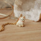 Tiny cat necklace with a pink bow