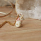 Tiny cat necklace with a pink bow