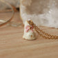 Tiny cat necklace with a pink bow