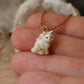 Tiny cat necklace with a pink bow