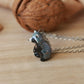 Raccoon necklace in a nutshell box