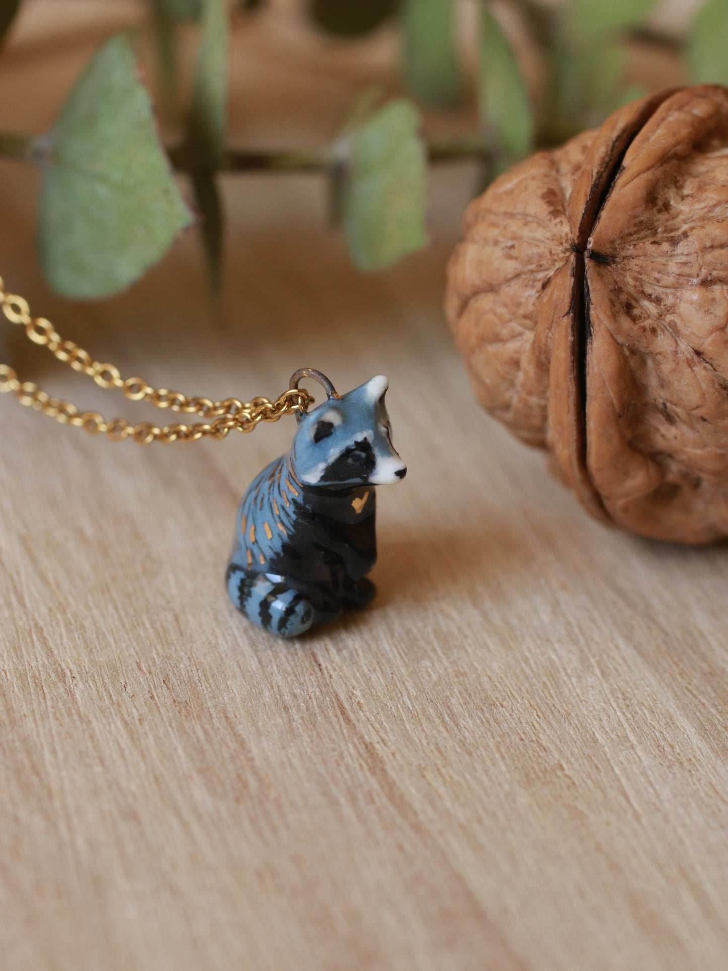 Raccoon necklace in a nutshell box