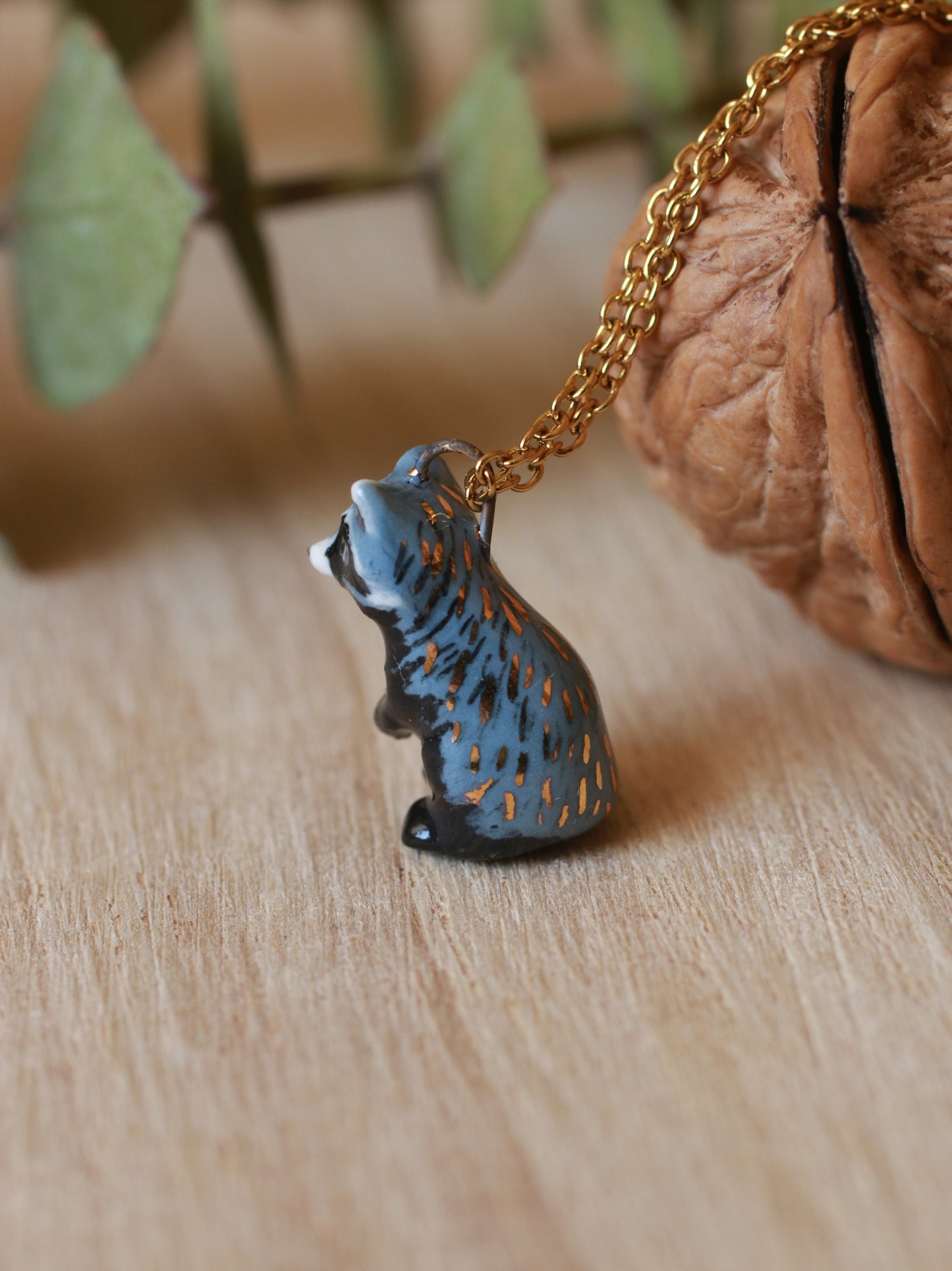 Raccoon necklace in a nutshell box