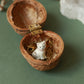 Tiny white cat necklace in a walnut box