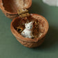 Tiny white cat necklace in a walnut box