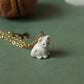 Tiny white cat necklace in a walnut box