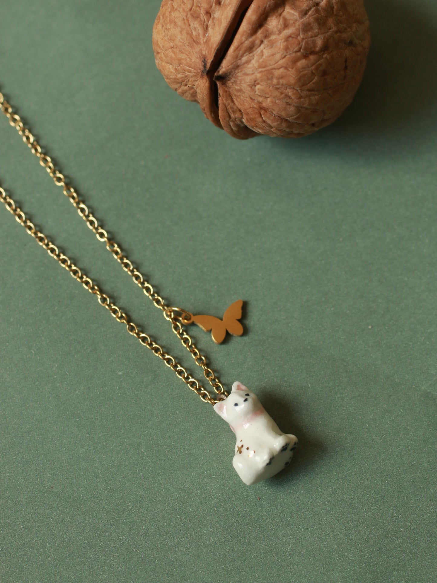 Tiny white cat necklace in a walnut box