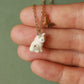 Tiny white cat necklace in a walnut box