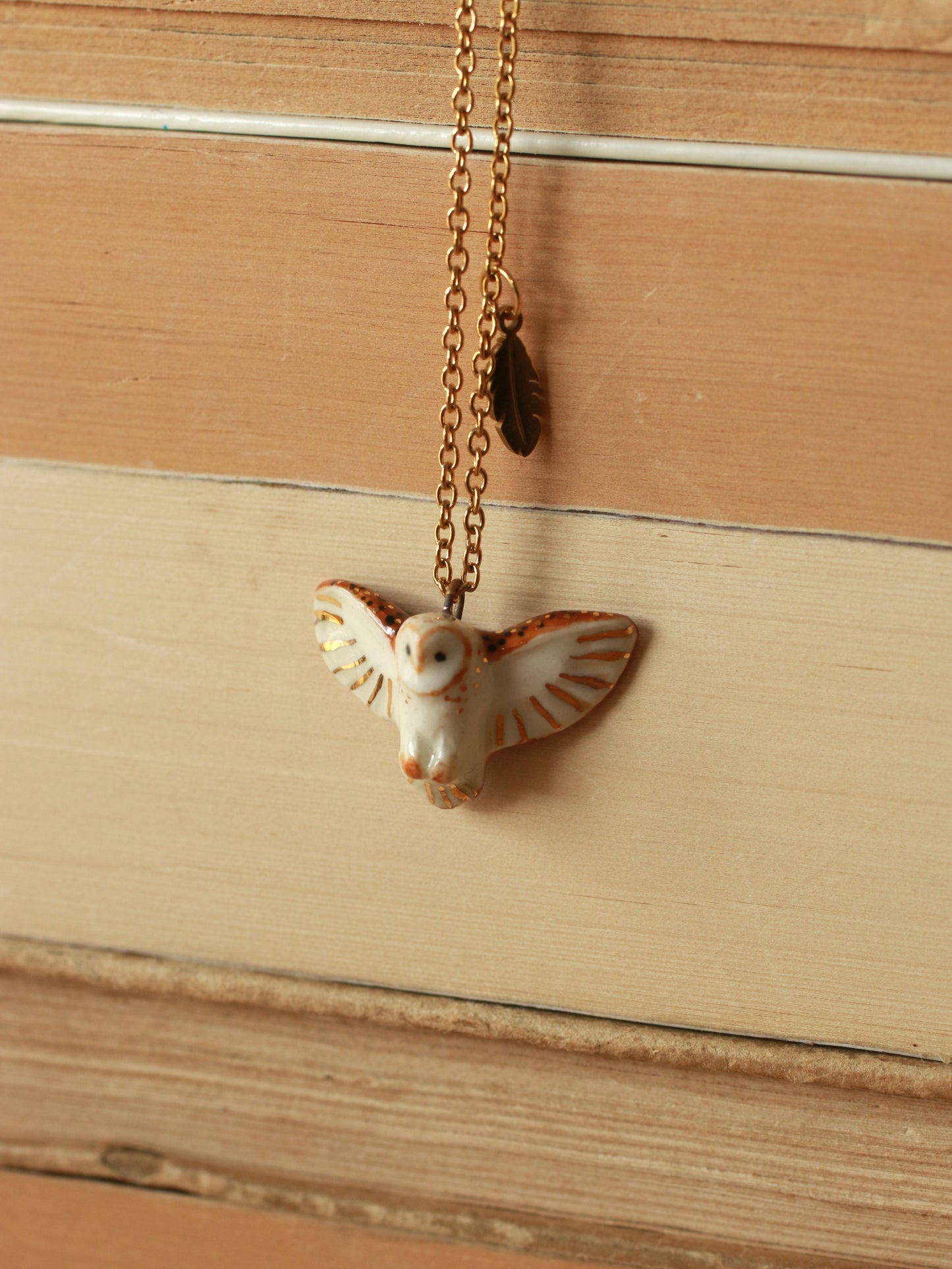 Barn owl necklace with a feather charm