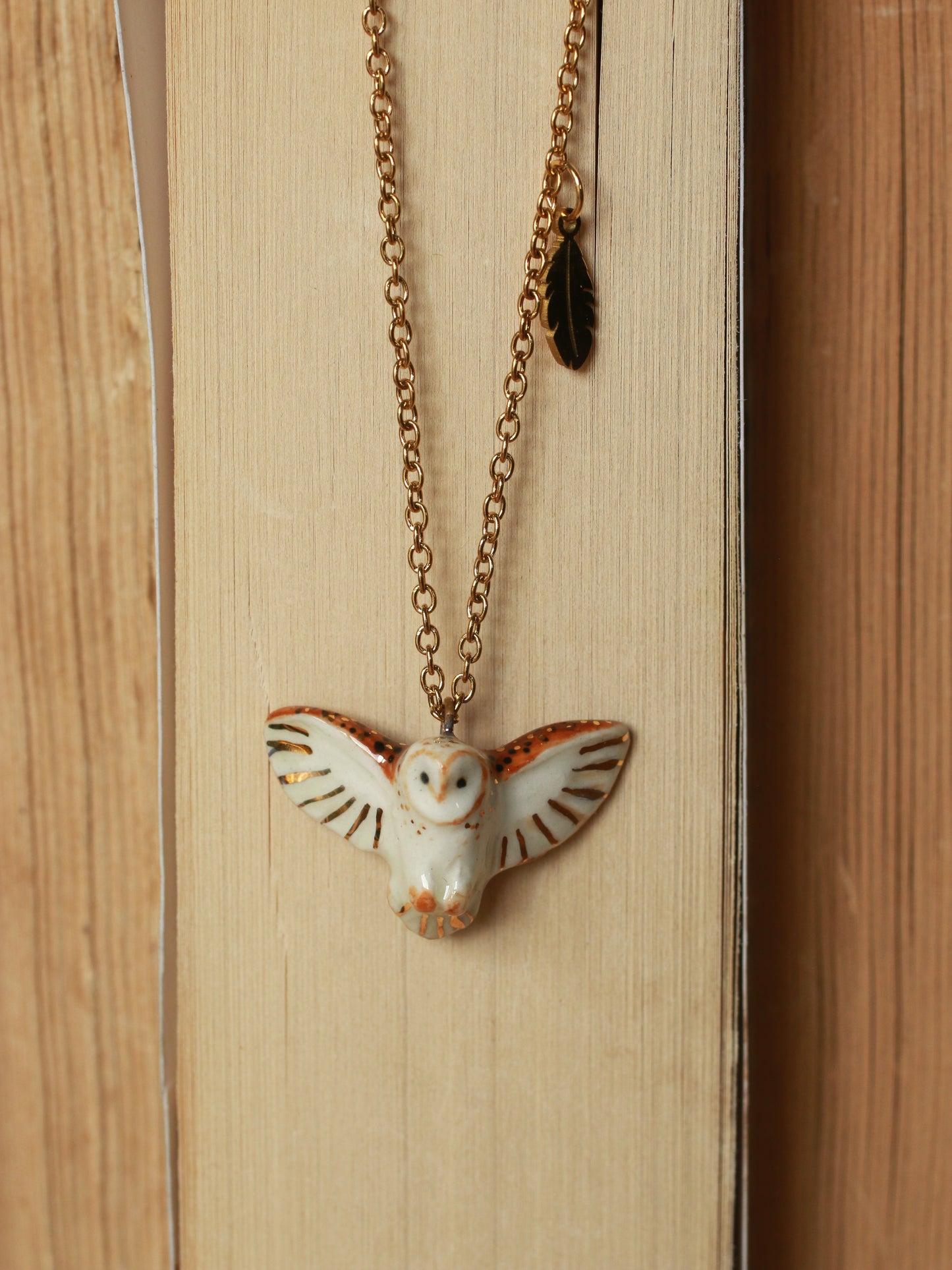 Barn owl necklace with a feather charm