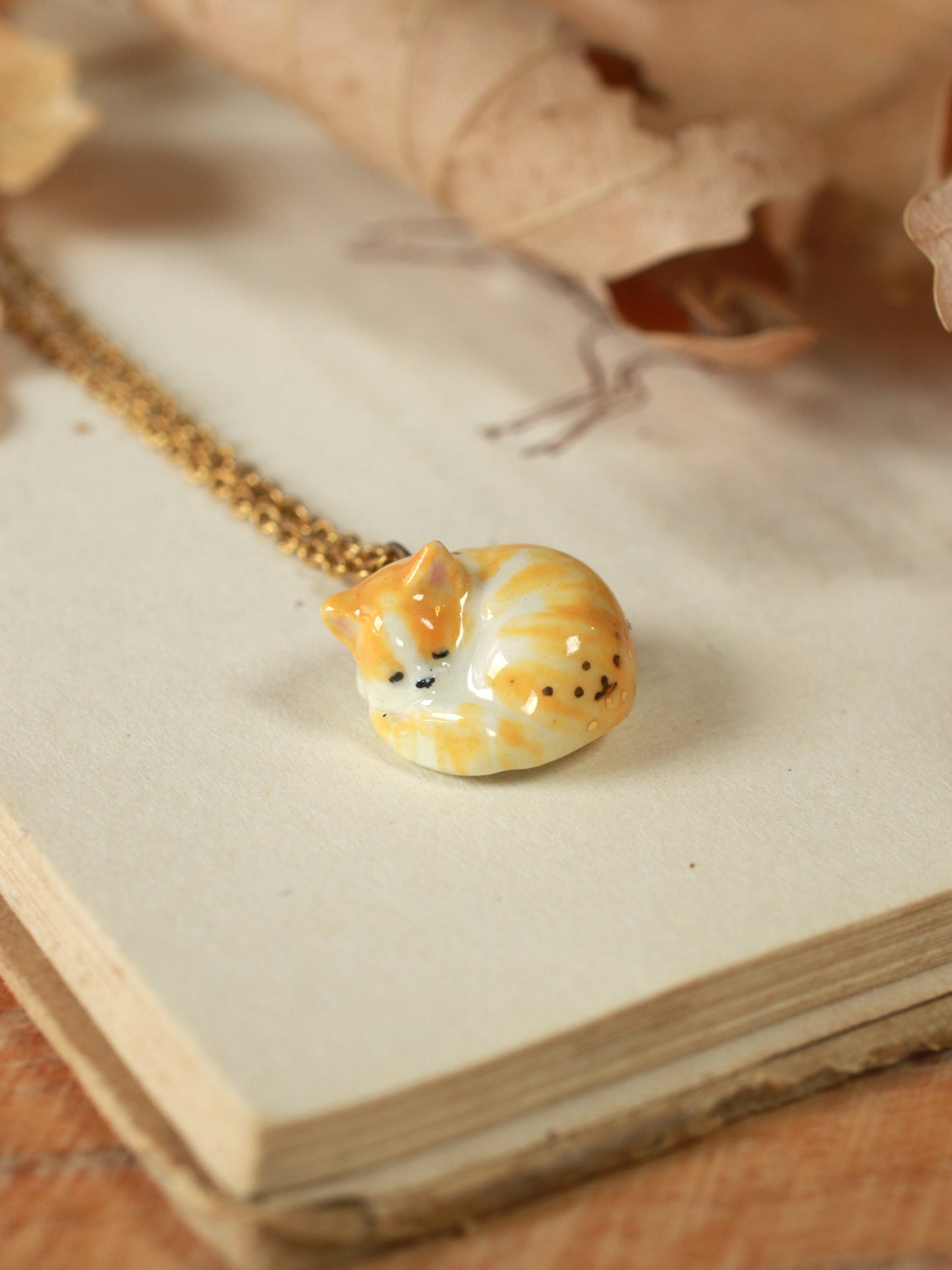 Sleeping orange tabby cat necklace