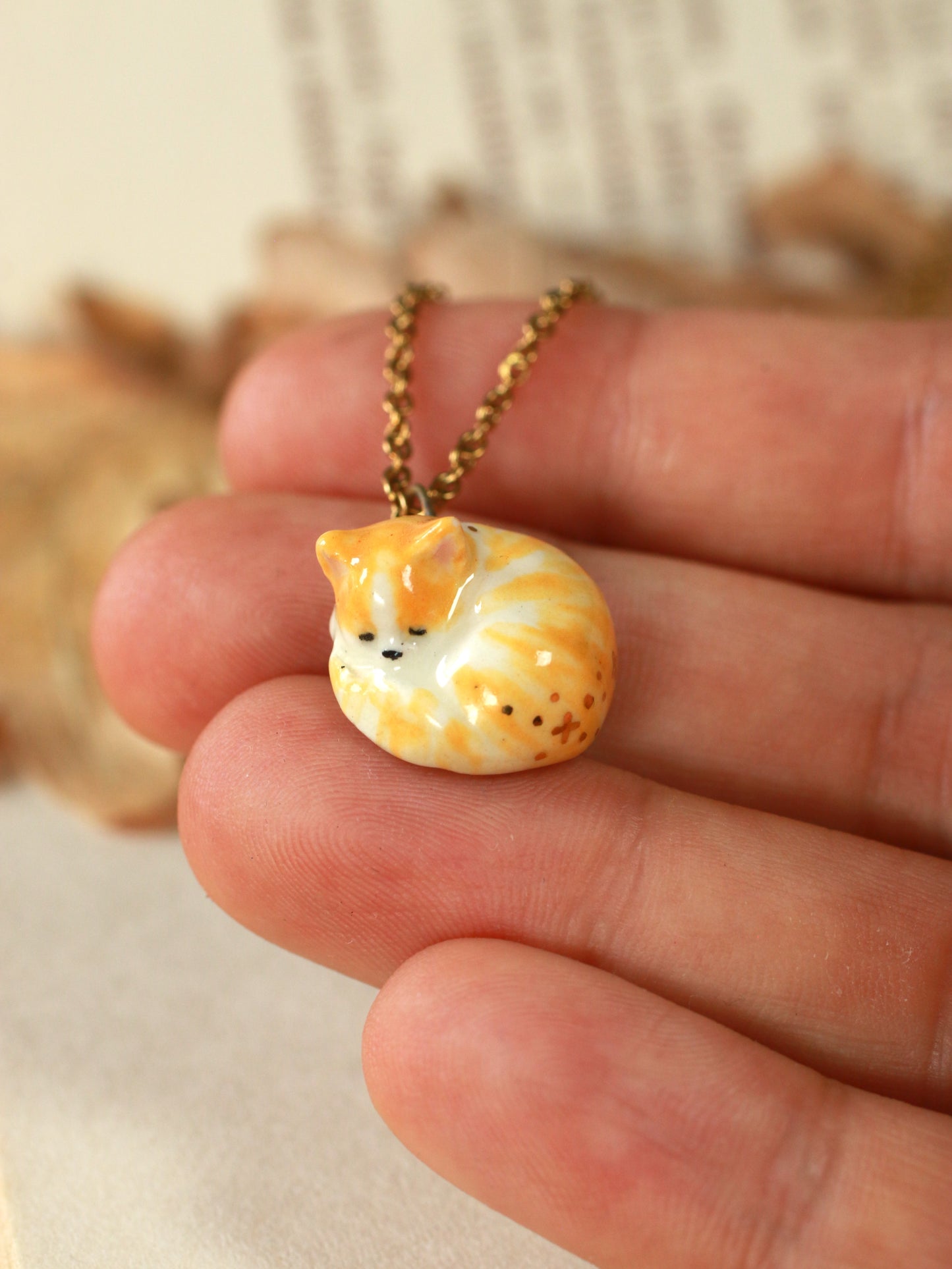 Sleeping orange tabby cat necklace