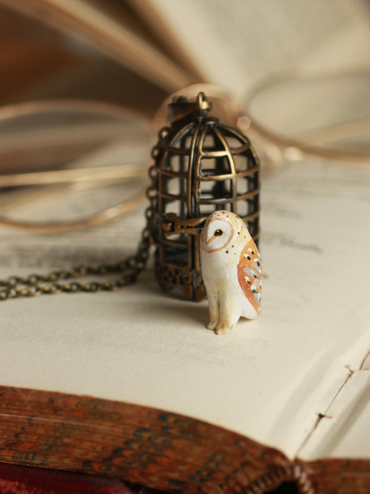 Barn owl figure in a cage necklace